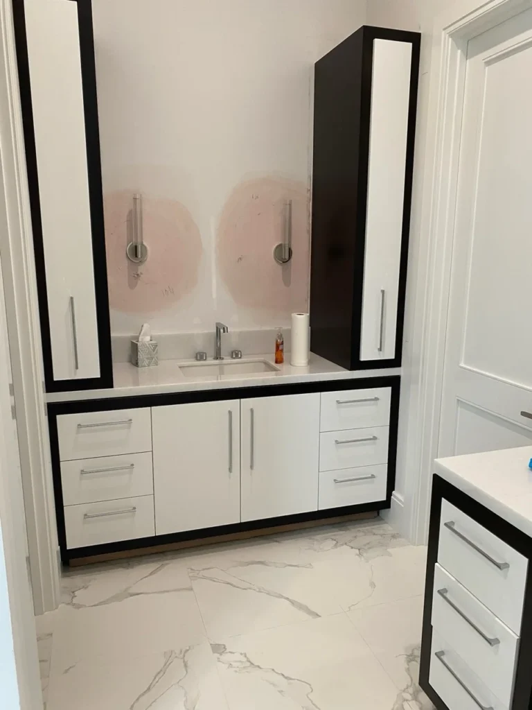 Modern black and white bathroom vanity with two tall storage towers