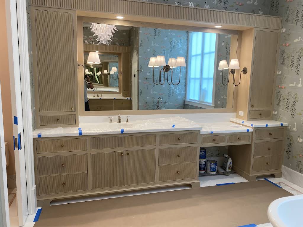 Full-wall double vanity composition with integrated mirrors, lighting and storage towers