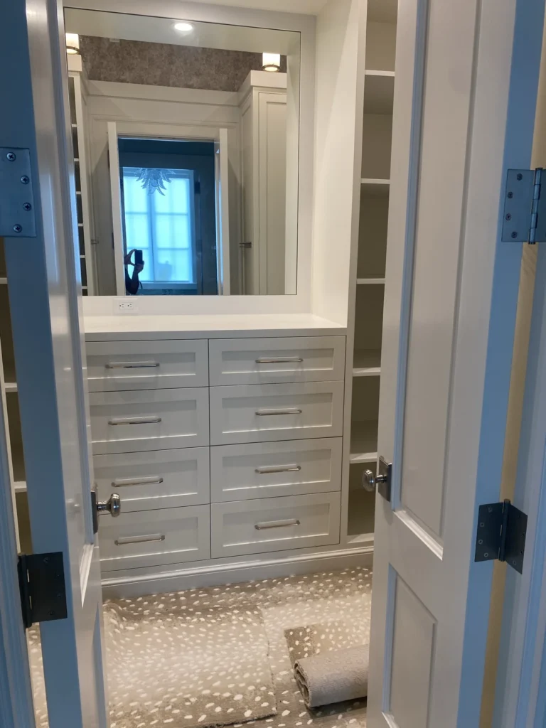White closet vanity and dressing station with illuminated mirror and drawer storage