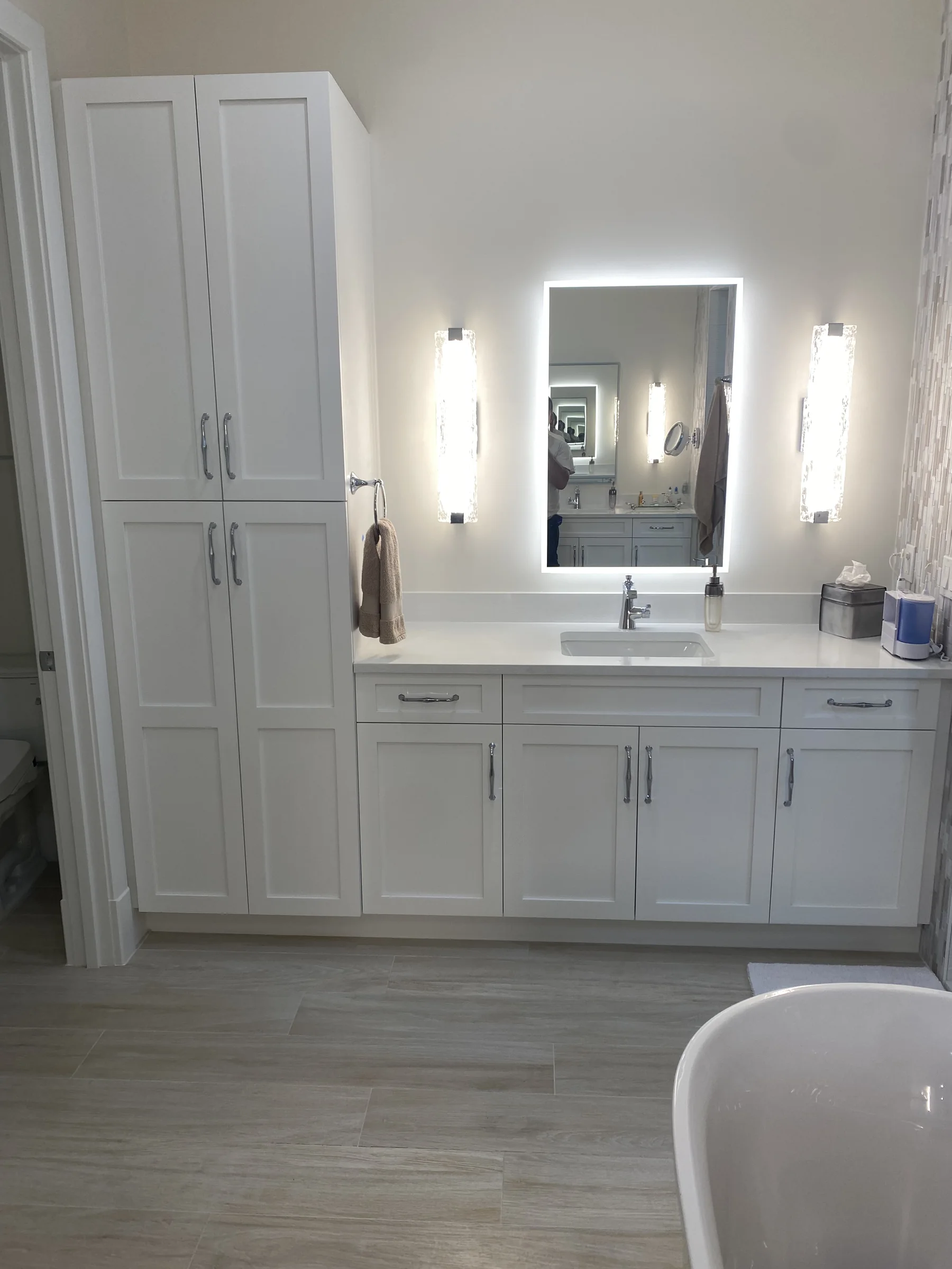White custom vanity with full-height storage and a clean integrated elevation